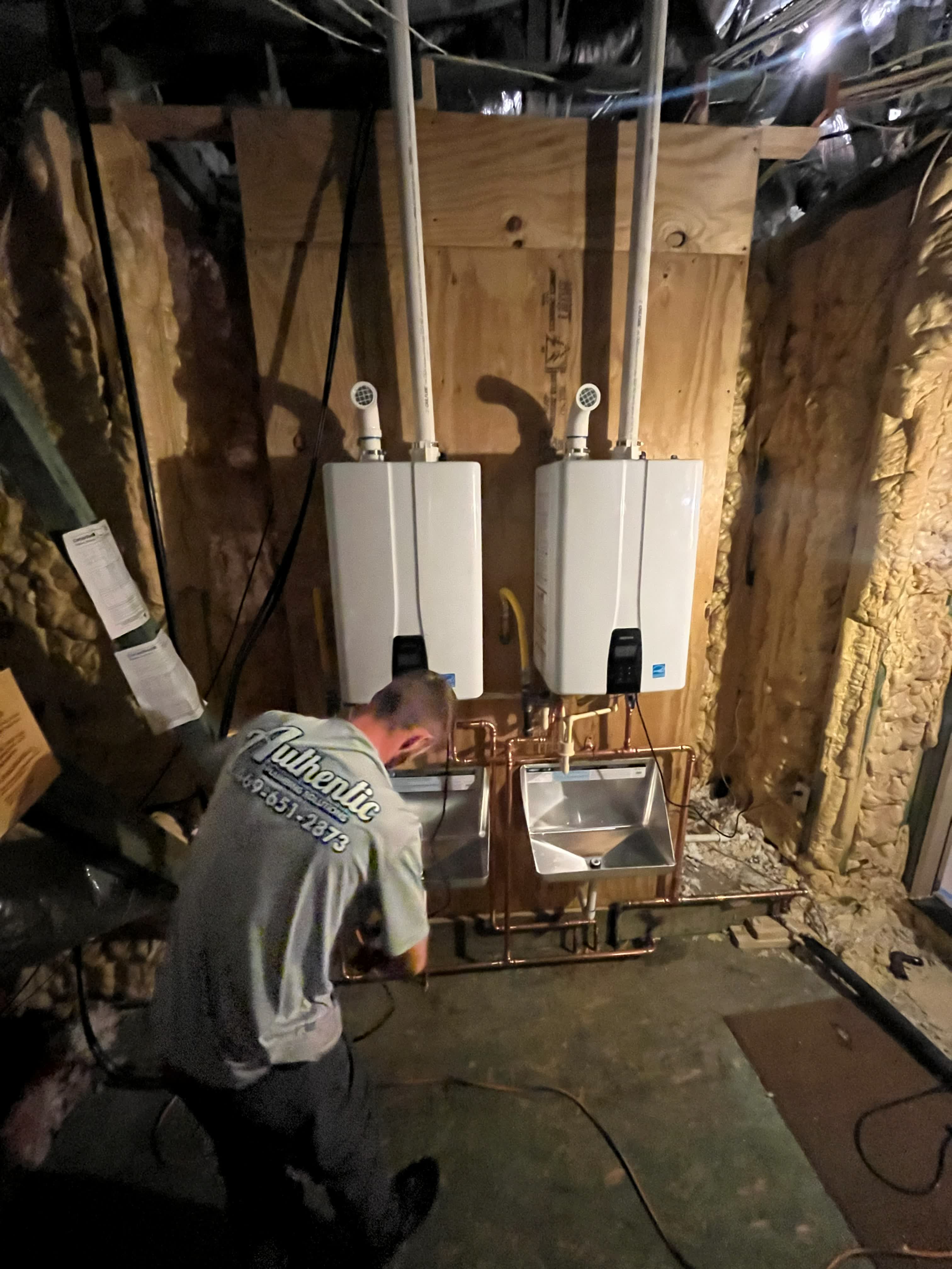 Two tankless units being installed side by side