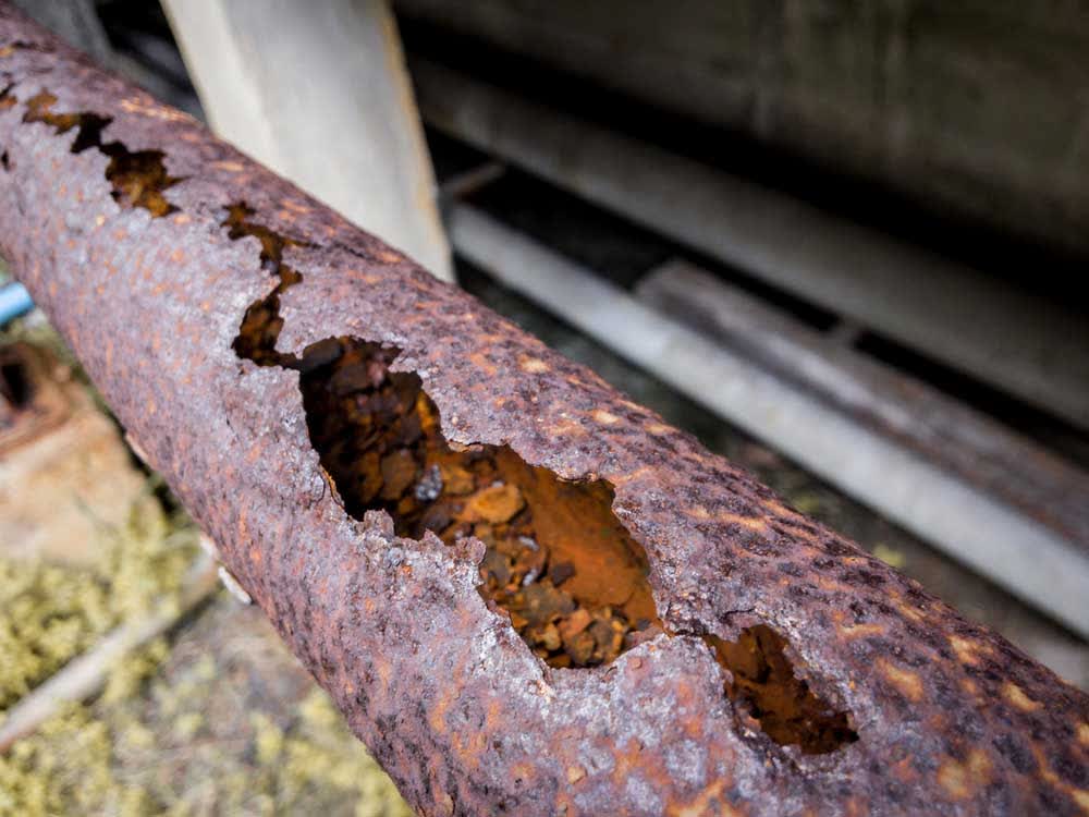 Cast iron drain pipe corroded through at the wall
