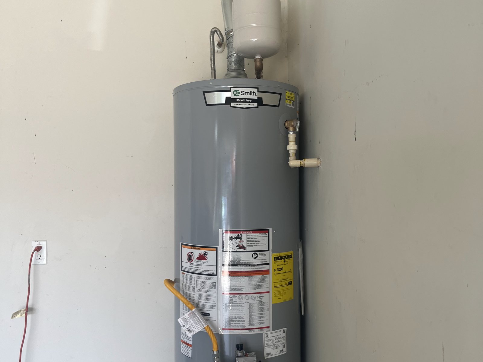 Tank water heater installed in a garage with an expansion tank