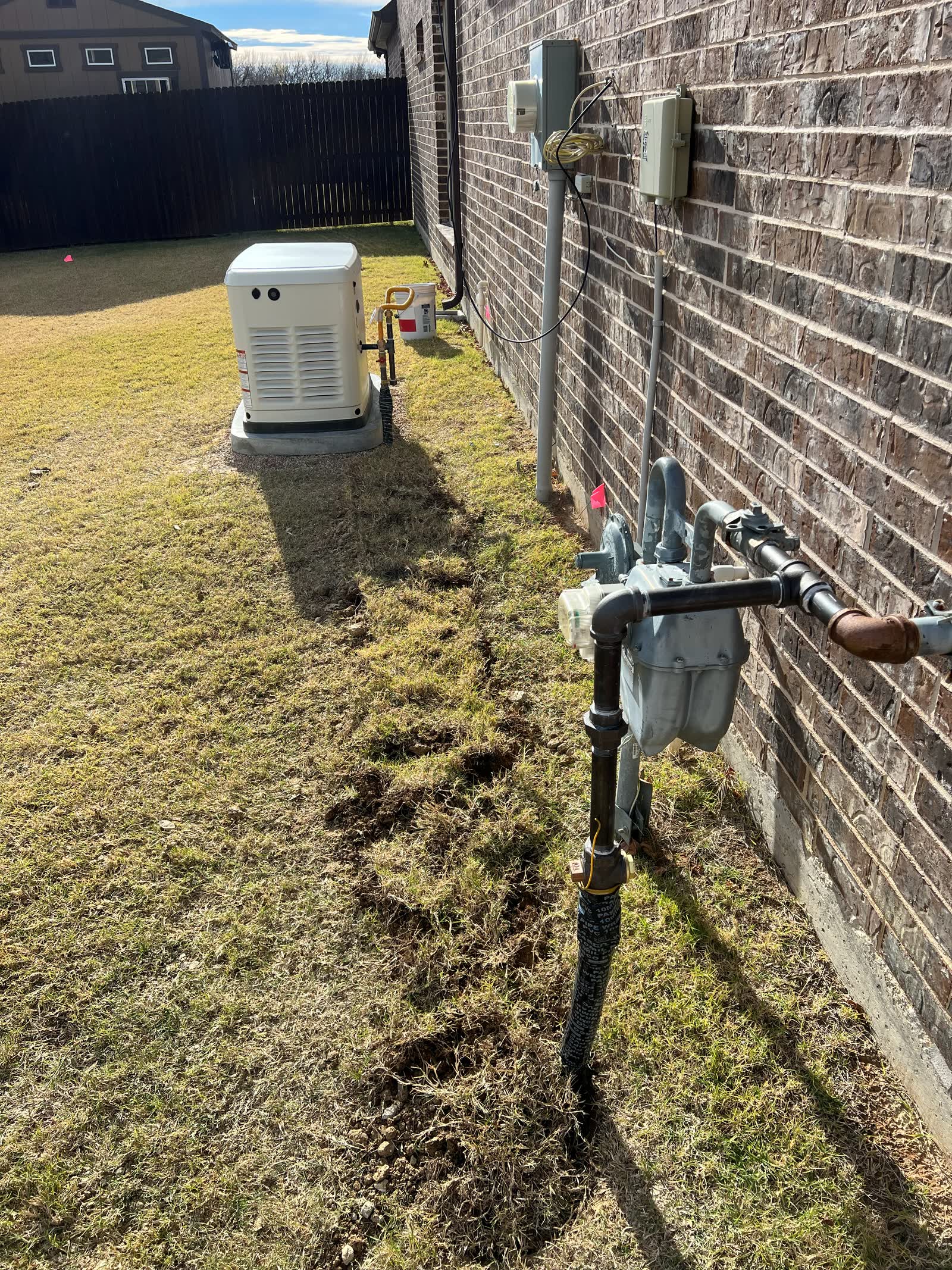 Gas meter with a yard line run along the house to a standby generator