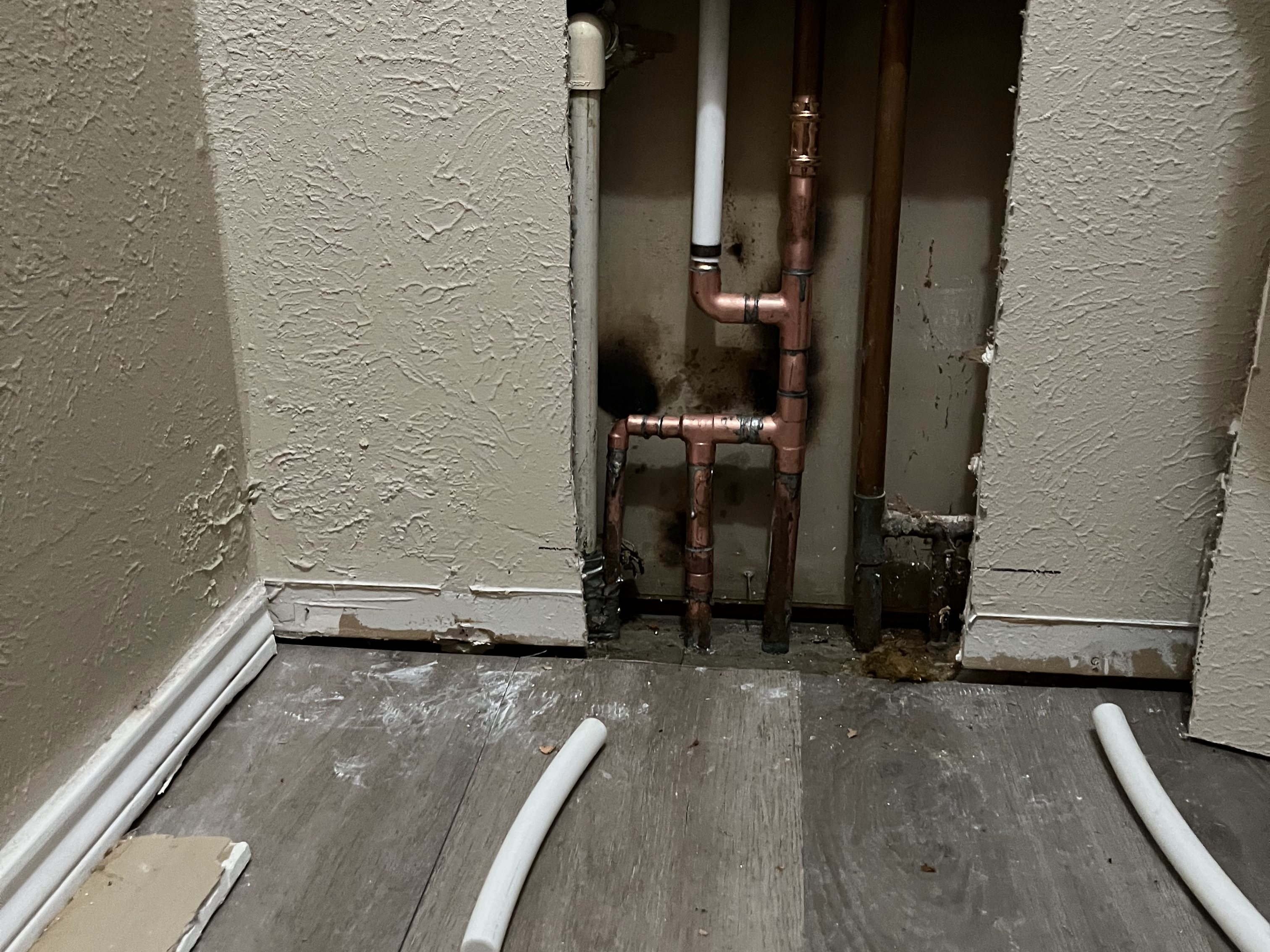 Wall opened to reach and repair a leaking copper supply line