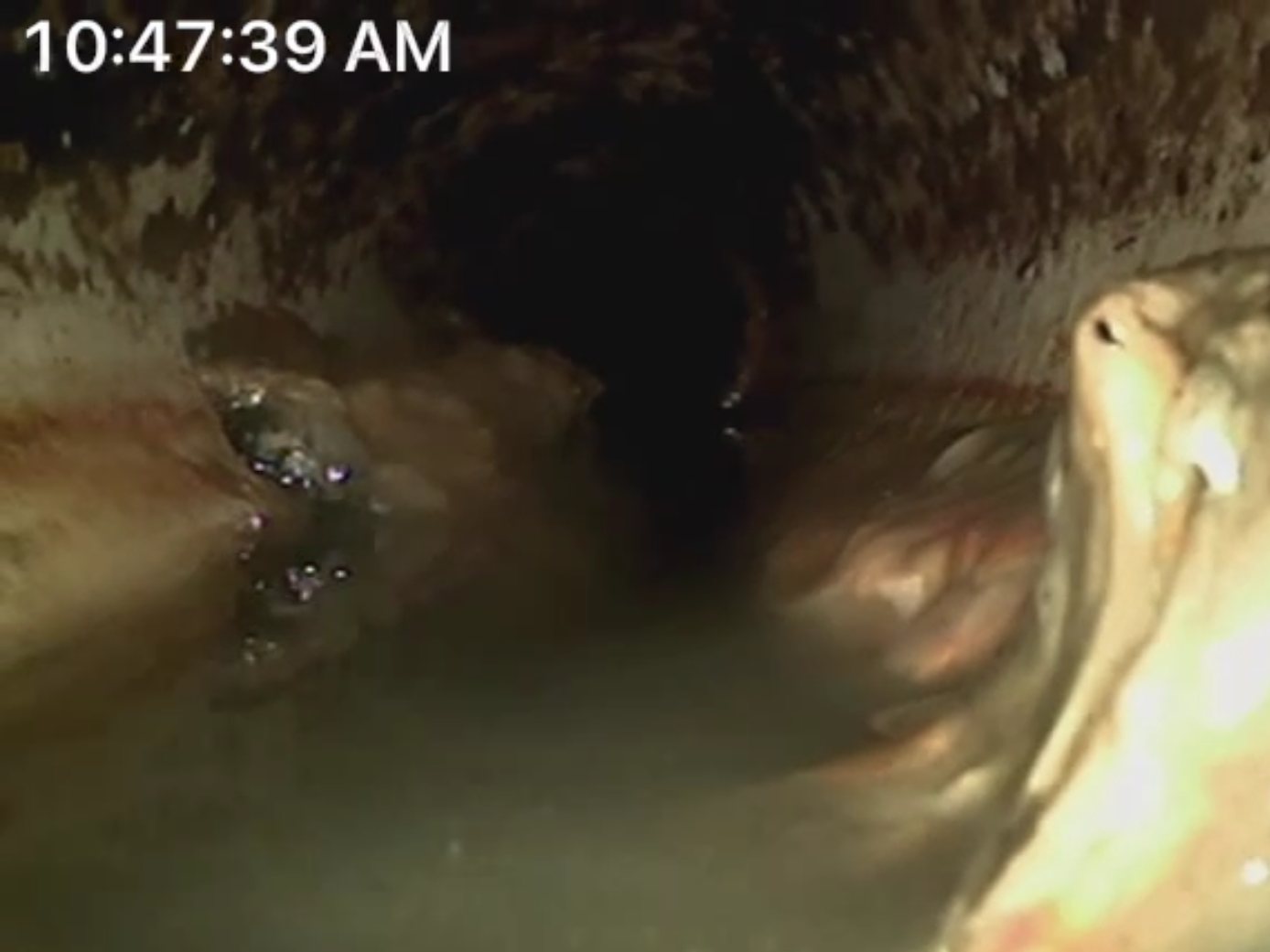 Sewer camera inspection inside a scaled drain line, 33 feet down