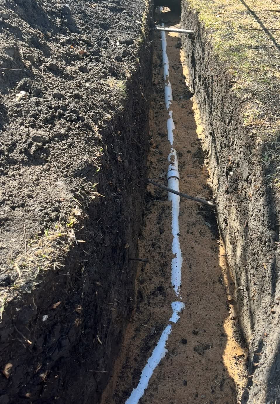 New sewer line laid in an open trench during an underground line replacement